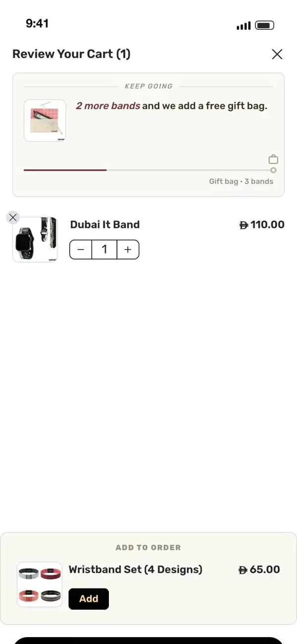 The zamani cart with the gift-bag goal and the add-to-order offer highlighted: two more bands unlock the free gift bag, then the wristband set is added in one tap